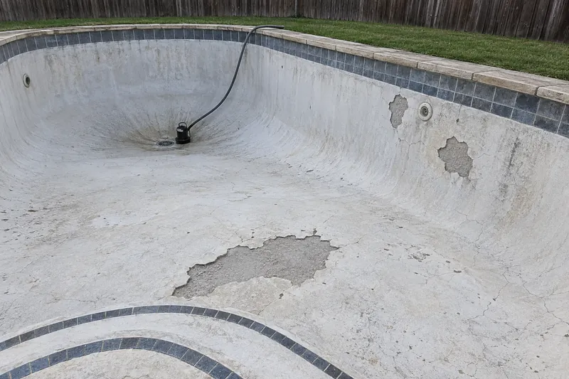 Plaster popped off to bare gunite in a drained pool