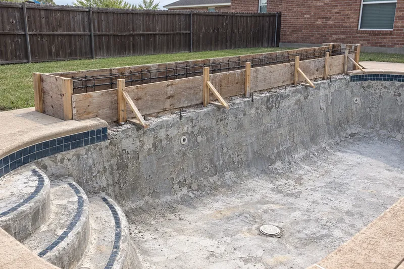 Forms and rebar for a raised wall on an existing pool's bond beam